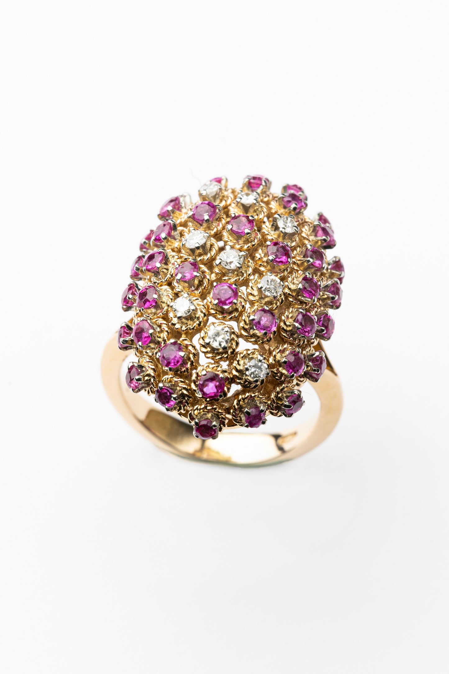 An 18 kt cocktail ring with diamonds and purplish/pink sapphires